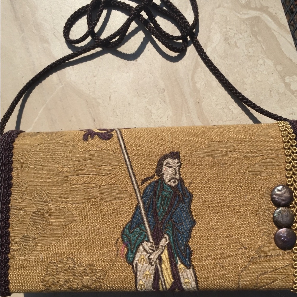 One of a kind clutch handbag with long strap.